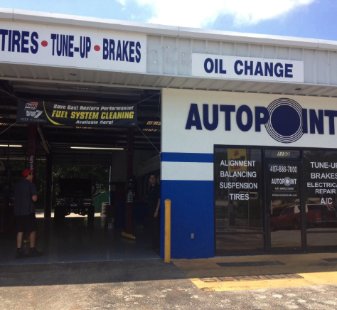 Auto Point Car Care Building with Technicians